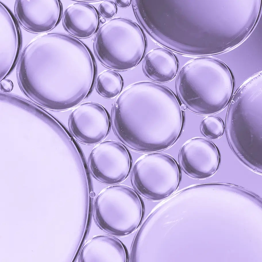 Macro photograph of lilac-toned oil bubbles