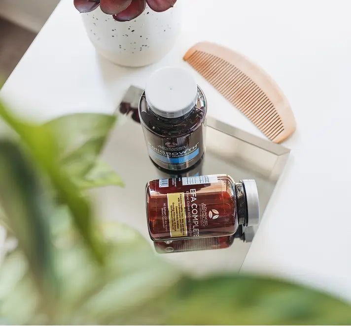 EFA Complete and a supplement bottle beside a wooden comb