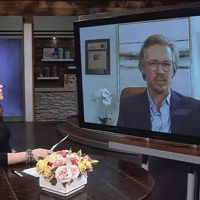 William Gaunitz appearing by video on a TV news set