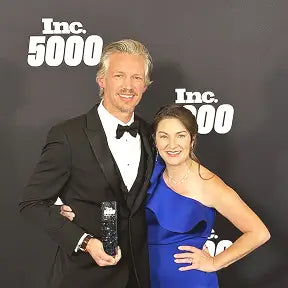 William Gaunitz holding an award at the Inc. 5000 event